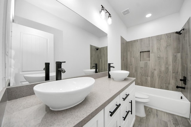 673 Rd 5822, Cleveland, TX 77327 - bathroom featuring toilet, shower / washtub combination, double vanity, and recessed lighting