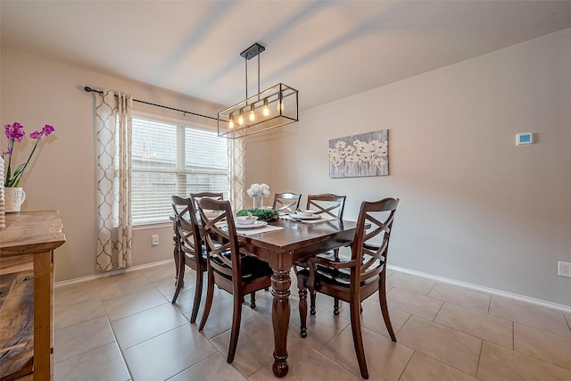 23806 Naples Shore Dr, Katy, TX 77493 - dining room featuring light tile patterned flooring, baseboards, and an inviting chandelier