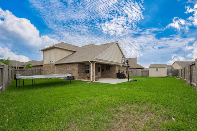 23806 Naples Shore Dr, Katy, TX 77493 - rear view of house with an outbuilding, a fenced backyard, a patio, brick siding, and a trampoline