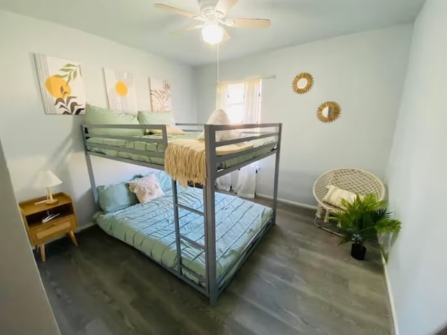 bedroom with ceiling fan, baseboards, and wood finished floors