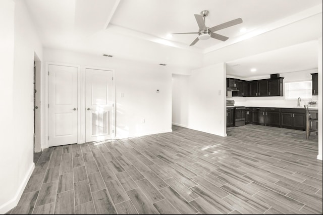 312 N Alamo St, Alton, TX 78573 - unfurnished living room with a raised ceiling, light wood-style floors, ceiling fan, and visible vents