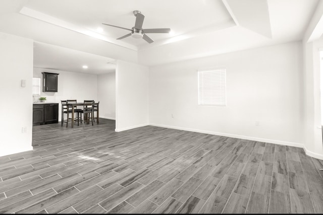 312 N Alamo St, Alton, TX 78573 - living room with baseboards, wood finished floors, a tray ceiling, and a ceiling fan