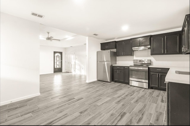 312 N Alamo St, Alton, TX 78573 - kitchen featuring light countertops, appliances with stainless steel finishes, light wood-style flooring, under cabinet range hood, and visible vents