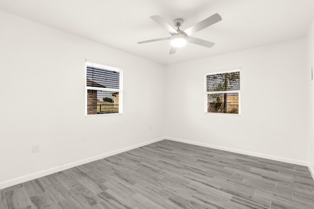 312 N Alamo St, Alton, TX 78573 - spare room featuring plenty of natural light, baseboards, wood finished floors, and a ceiling fan