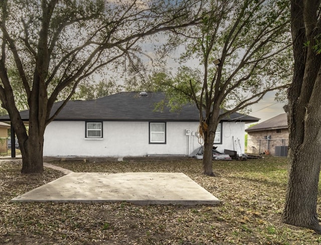 312 N Alamo St, Alton, TX 78573 - rear view of house with central air condition unit, a patio area, stucco siding, and fence