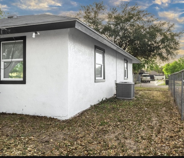 312 N Alamo St, Alton, TX 78573 - view of side of home with stucco siding, central AC, and fence