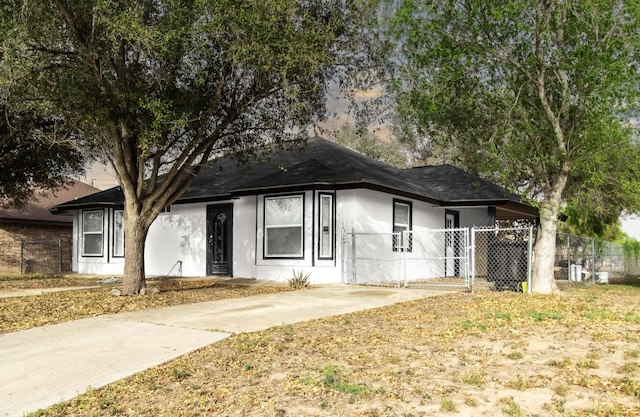 312 N Alamo St, Alton, TX 78573 - ranch-style home featuring stucco siding, fence, and a shingled roof