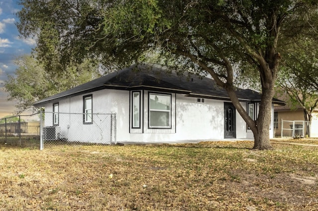 312 N Alamo St, Alton, TX 78573 - view of side of home featuring fence and stucco siding