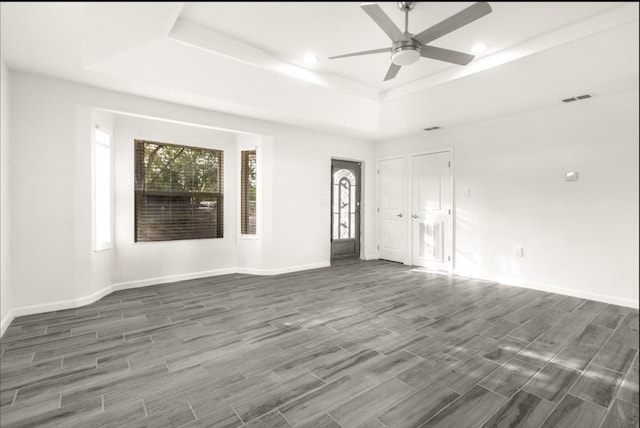 312 N Alamo St, Alton, TX 78573 - unfurnished room with ceiling fan, visible vents, a raised ceiling, and dark wood-style flooring