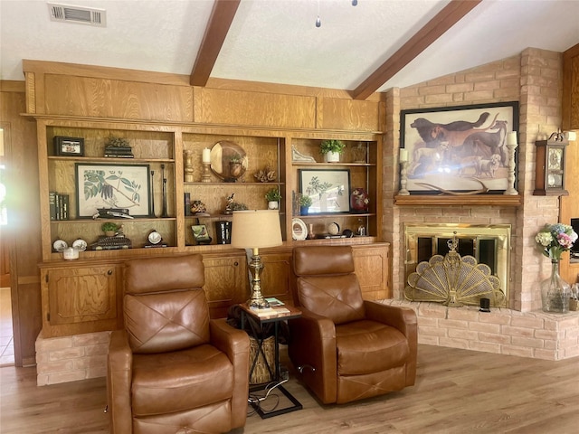69 Greenbriar Dr, Conroe, TX 77304 - living room featuring wood finished floors, a brick fireplace, built in features, and wooden walls