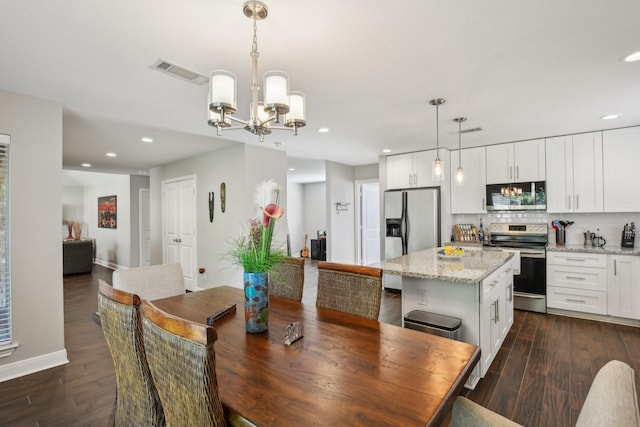 1006 Glacier Hill Dr, Houston, TX 77077 - dining area with a chandelier, dark wood-style floors, recessed lighting, and baseboards