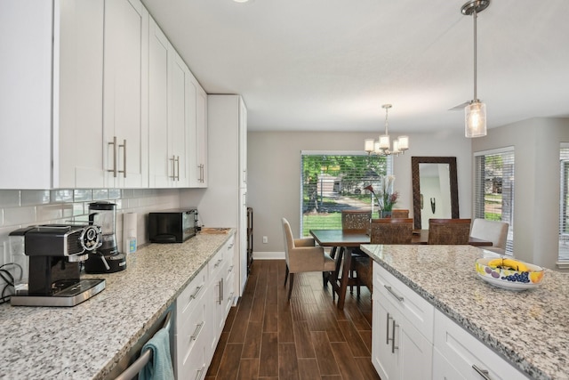 1006 Glacier Hill Dr, Houston, TX 77077 - kitchen featuring plenty of natural light, baseboards, white cabinetry, and decorative backsplash