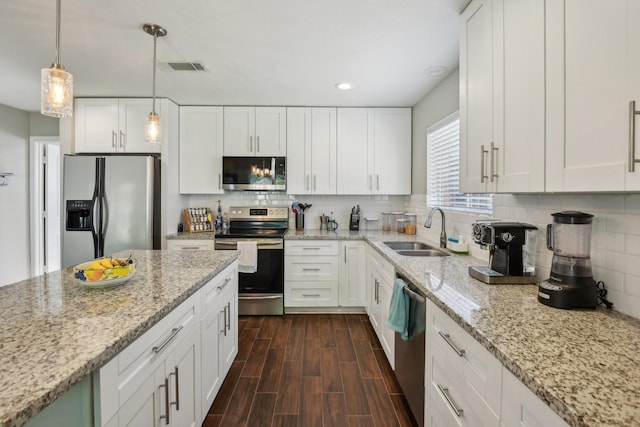 1006 Glacier Hill Dr, Houston, TX 77077 - kitchen featuring stainless steel appliances, a sink, white cabinetry, and recessed lighting