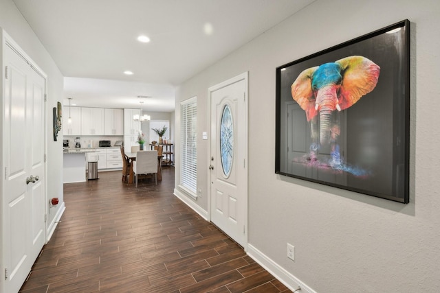 1006 Glacier Hill Dr, Houston, TX 77077 - foyer with dark wood-type flooring, recessed lighting, a chandelier, and baseboards