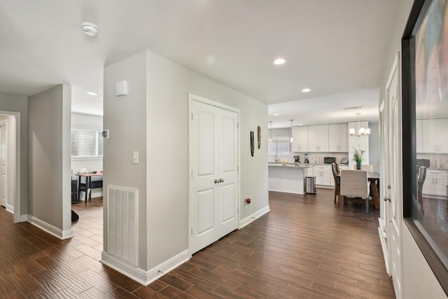 1006 Glacier Hill Dr, Houston, TX 77077 - hallway with recessed lighting, baseboards, dark wood-type flooring, a chandelier, and plenty of natural light