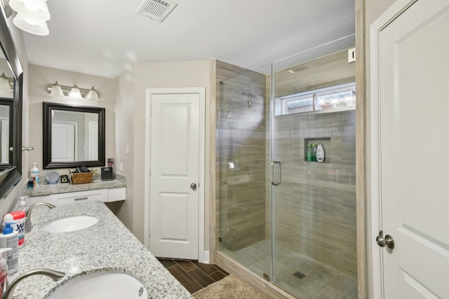 1006 Glacier Hill Dr, Houston, TX 77077 - bathroom with double vanity, a stall shower, and wood finish floors