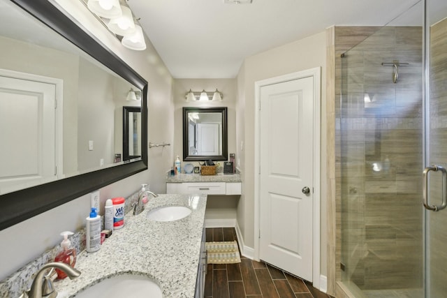 1006 Glacier Hill Dr, Houston, TX 77077 - bathroom with double vanity, a stall shower, wood finished floors, and baseboards