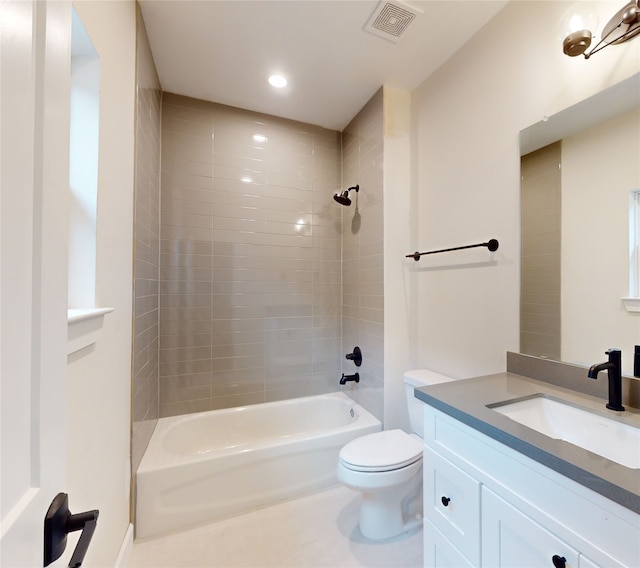 bathroom with visible vents, shower / washtub combination, toilet, vanity, and tile patterned flooring