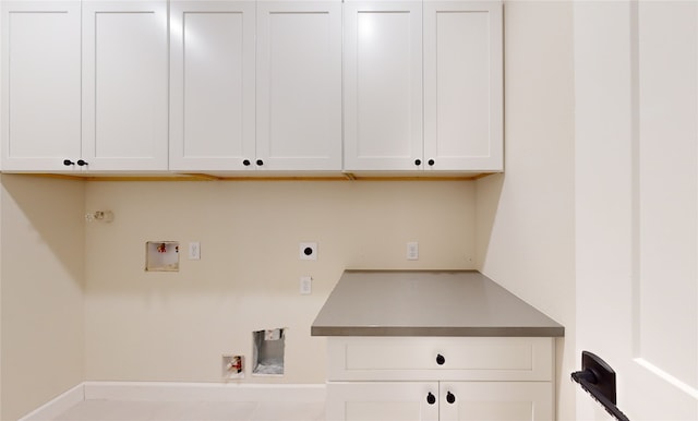 washroom with gas dryer hookup, electric dryer hookup, washer hookup, and cabinet space