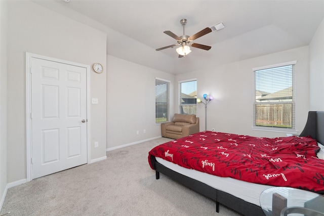 carpeted bedroom with baseboards, a ceiling fan, and visible vents