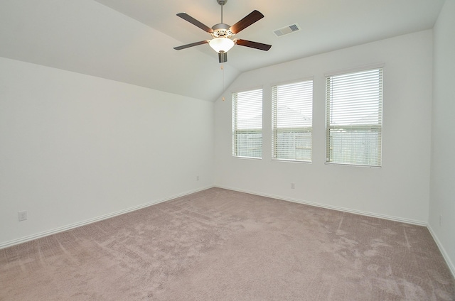 14211 Walworth Creek Ct, Rosharon, TX 77583 - spare room with a ceiling fan, light carpet, visible vents, baseboards, and vaulted ceiling