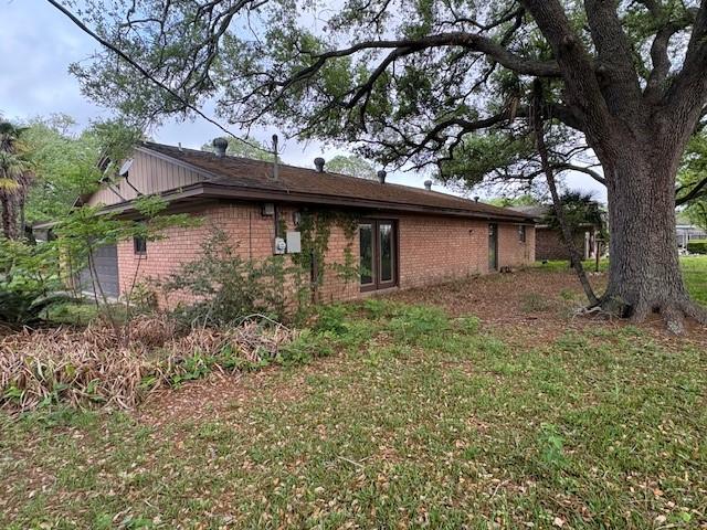 view of side of property with brick siding