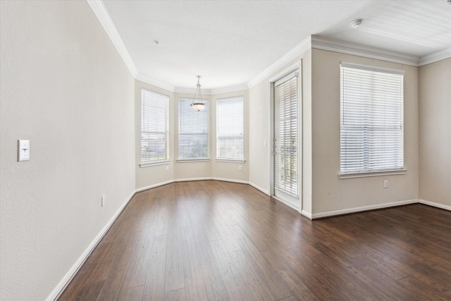unfurnished room with crown molding, baseboards, and dark wood-style floors