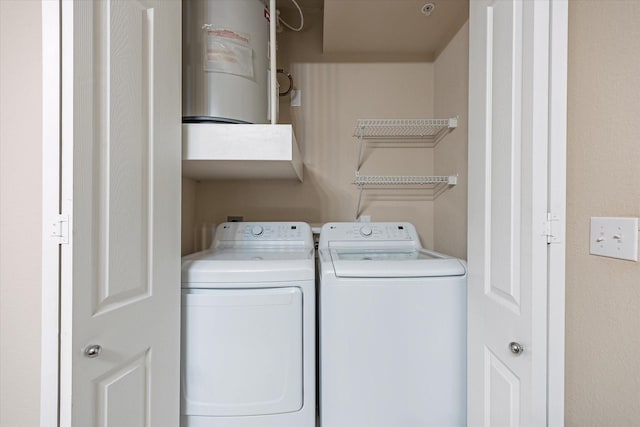 clothes washing area featuring independent washer and dryer and laundry area