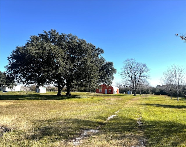 view of yard with a barn, a shed, and an outdoor structure