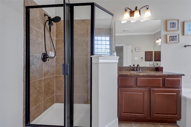 full bathroom featuring crown molding, vanity, visible vents, tile patterned floors, and a shower stall
