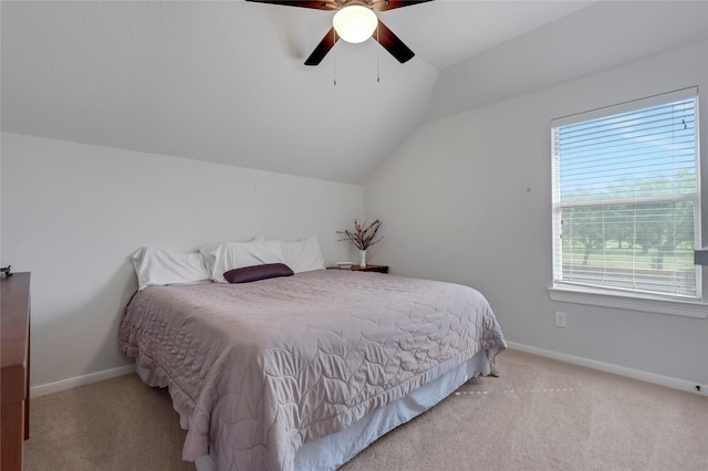 bedroom featuring baseboards, vaulted ceiling, and light carpet