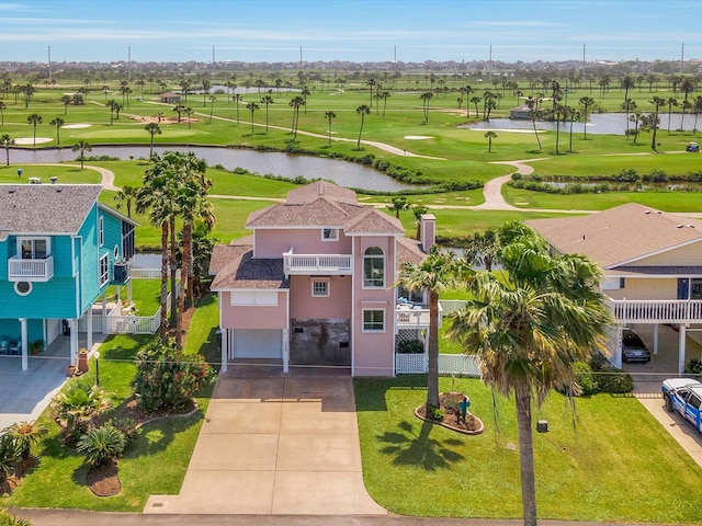drone / aerial view with view of golf course and a water view