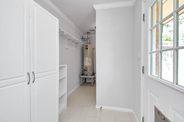 spacious closet with water heater and light tile patterned floors
