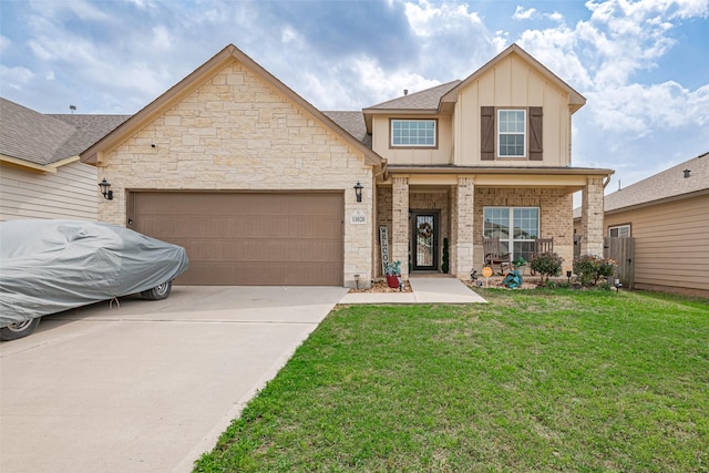 traditional-style home with concrete driveway, board and batten siding, stone siding, a front lawn, and a garage
