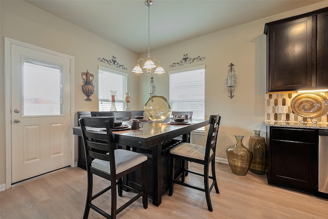 dining area featuring light wood-style flooring and baseboards