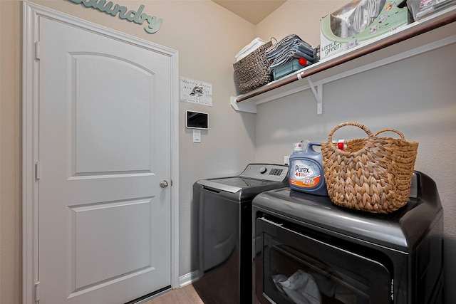 clothes washing area with laundry area and washer and clothes dryer