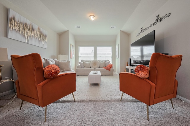 carpeted living area featuring baseboards and visible vents