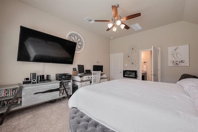 bedroom with visible vents, ensuite bathroom, a ceiling fan, carpet flooring, and lofted ceiling