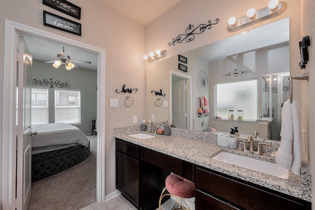 full bath with double vanity, ensuite bathroom, a sink, and a ceiling fan