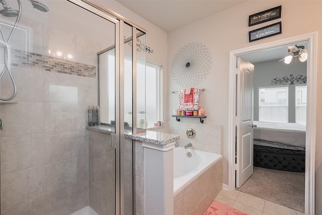bathroom featuring tile patterned flooring, ensuite bath, and a stall shower