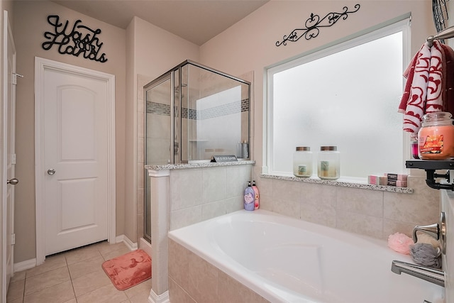 bathroom featuring a bath, a stall shower, and tile patterned floors