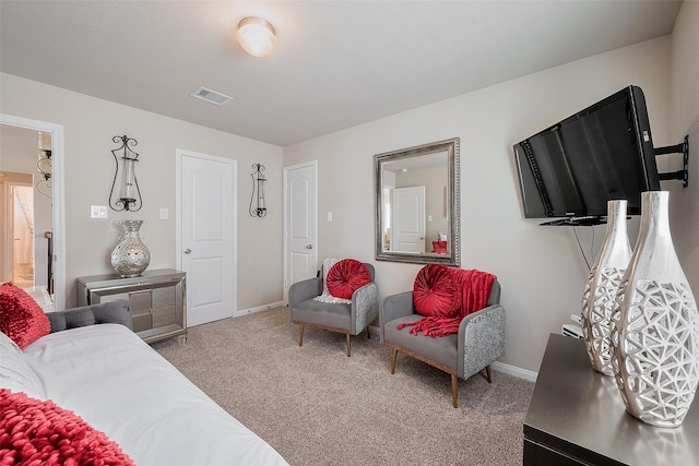 carpeted living area with baseboards and visible vents