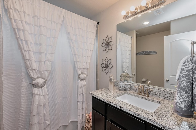 full bathroom featuring shower / bath combo, vanity, and visible vents
