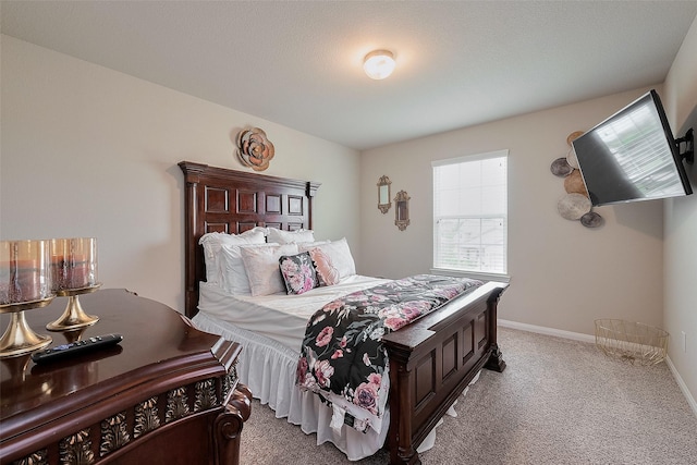 bedroom with baseboards and carpet