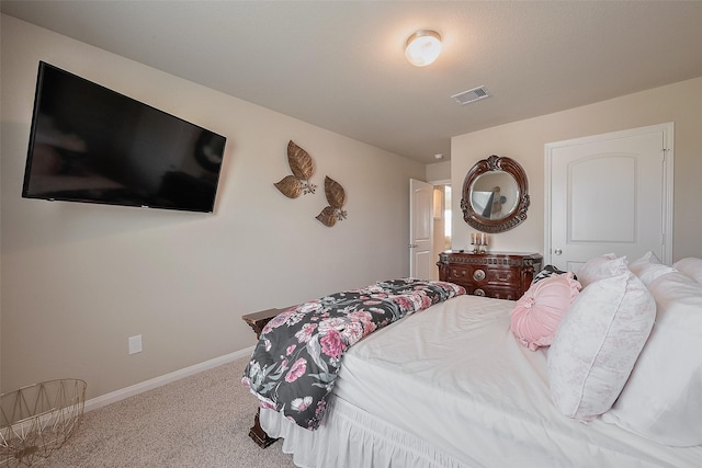 bedroom with carpet, visible vents, and baseboards