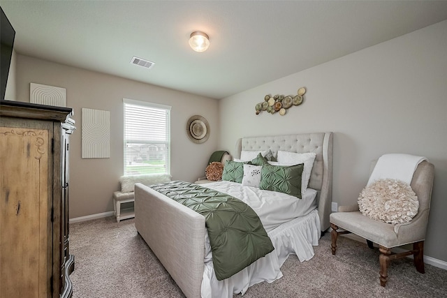 carpeted bedroom with visible vents and baseboards
