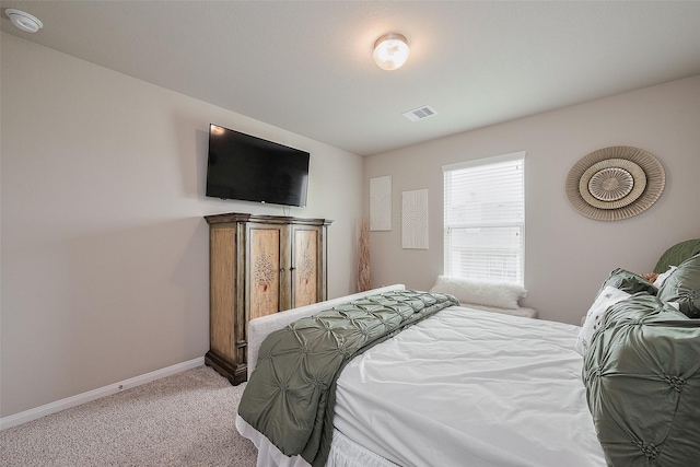 bedroom with light colored carpet, baseboards, and visible vents