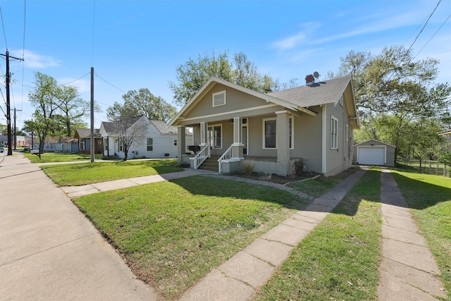 bungalow-style home with a garage, a porch, driveway, and a front yard