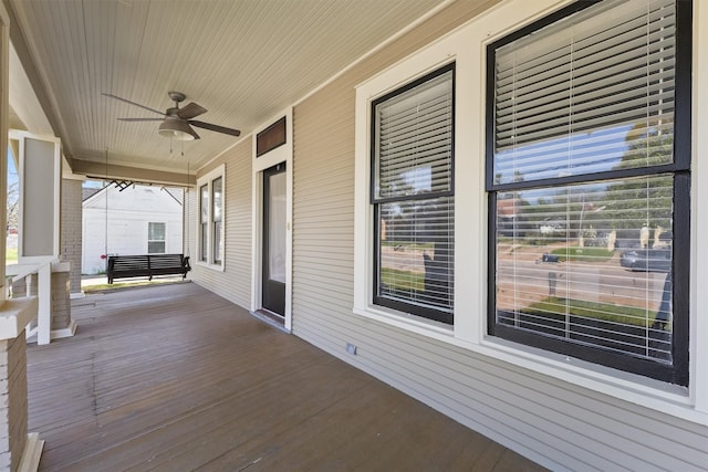 wooden terrace featuring a ceiling fan and covered porch