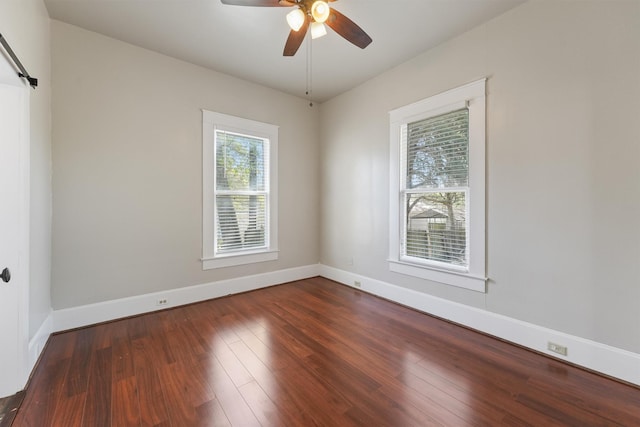 unfurnished room featuring wood finished floors, a ceiling fan, and baseboards